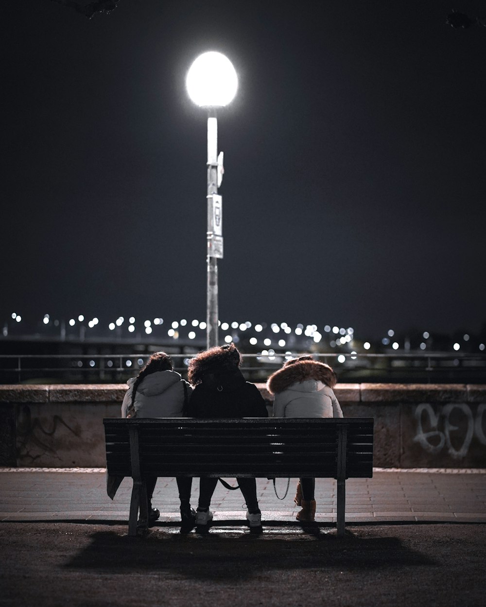 people sitting on bench during night time