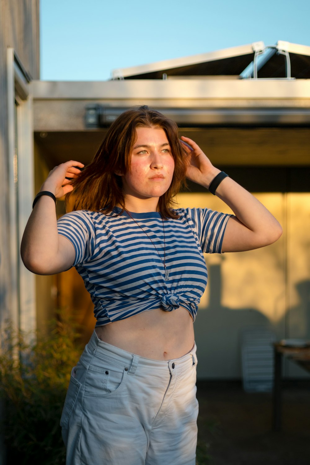 woman in black and white striped shirt and blue denim shorts