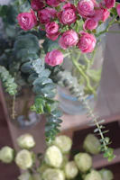 Close-up of a delicate pastel bouquet with eucalyptus and roses on a wooden table