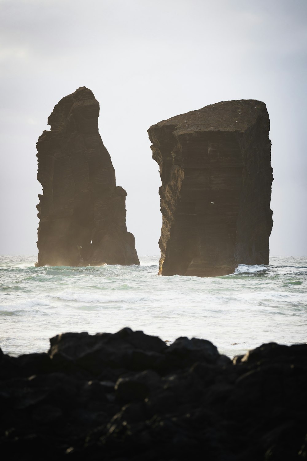 brown rock formation on sea during daytime