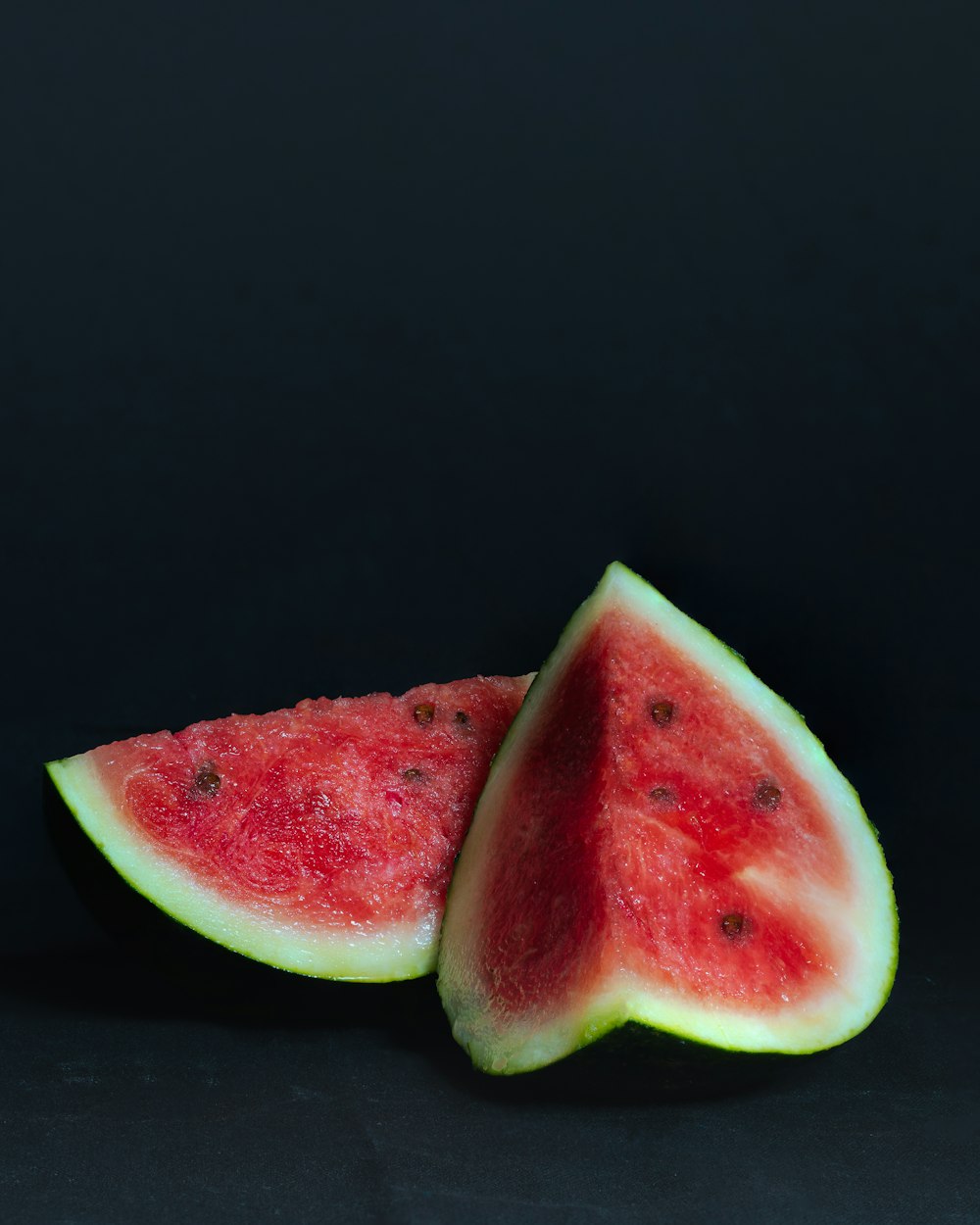 sliced watermelon on black background