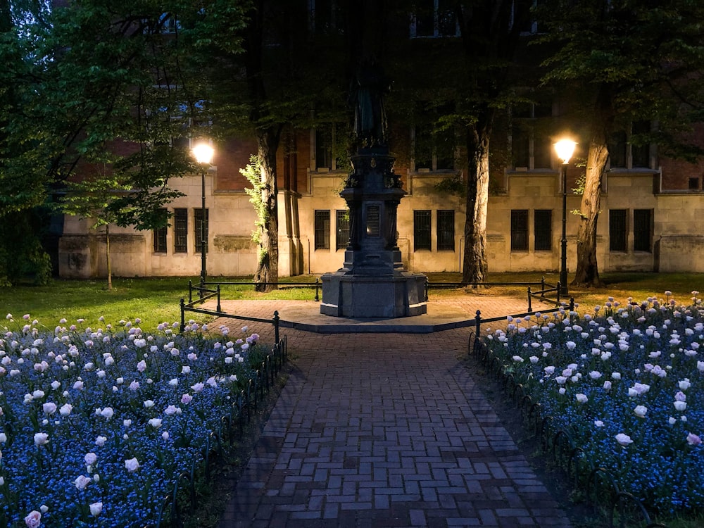 black and white concrete fountain in the middle of the street during night time