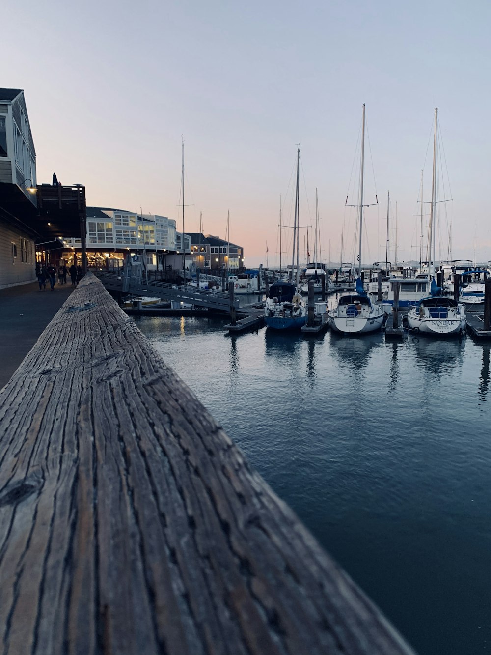 white and blue boats on dock during daytime