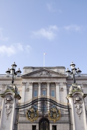 white concrete building with black metal fence