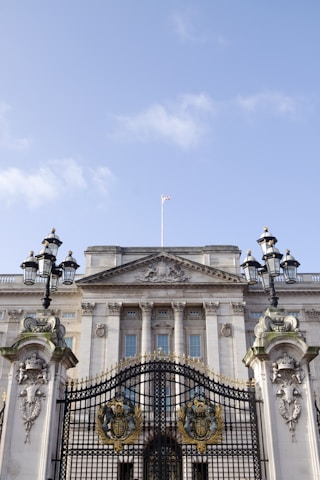 white concrete building with black metal fence