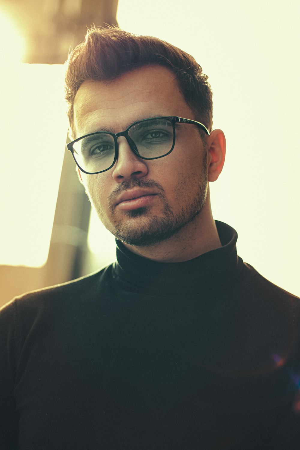 man in black crew neck shirt wearing black framed eyeglasses