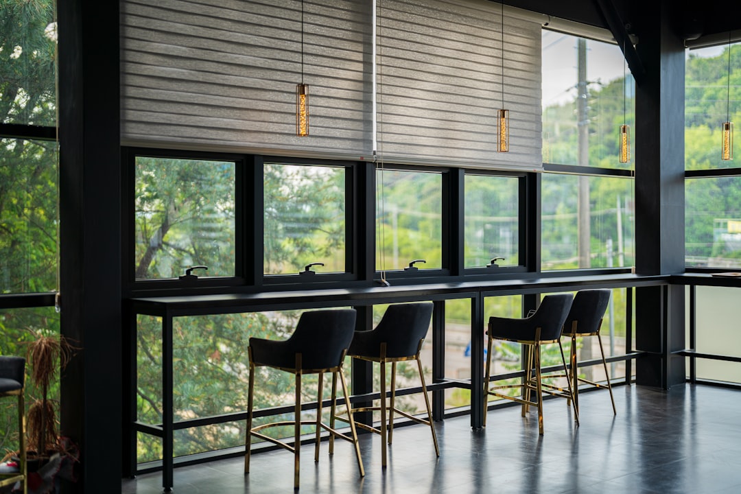 black metal framed chairs and table near window