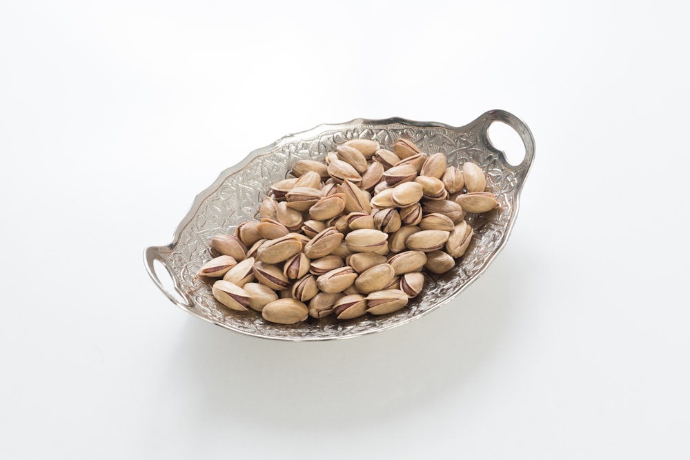 brown peanuts on stainless steel bowl