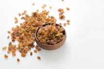 brown and white nuts on brown wooden bowl