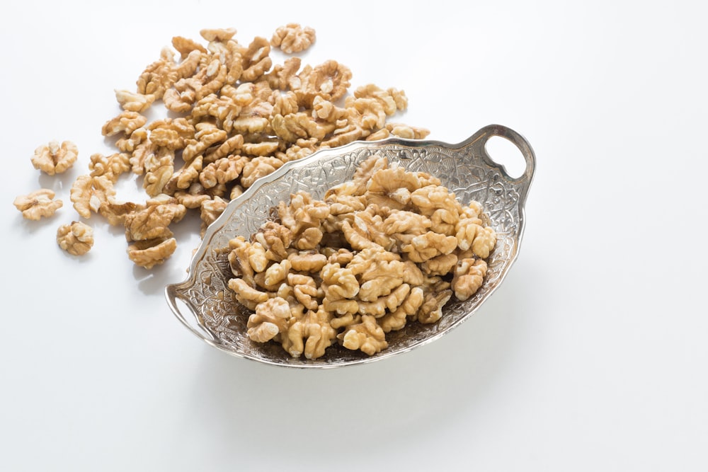 brown peanuts on stainless steel bowl