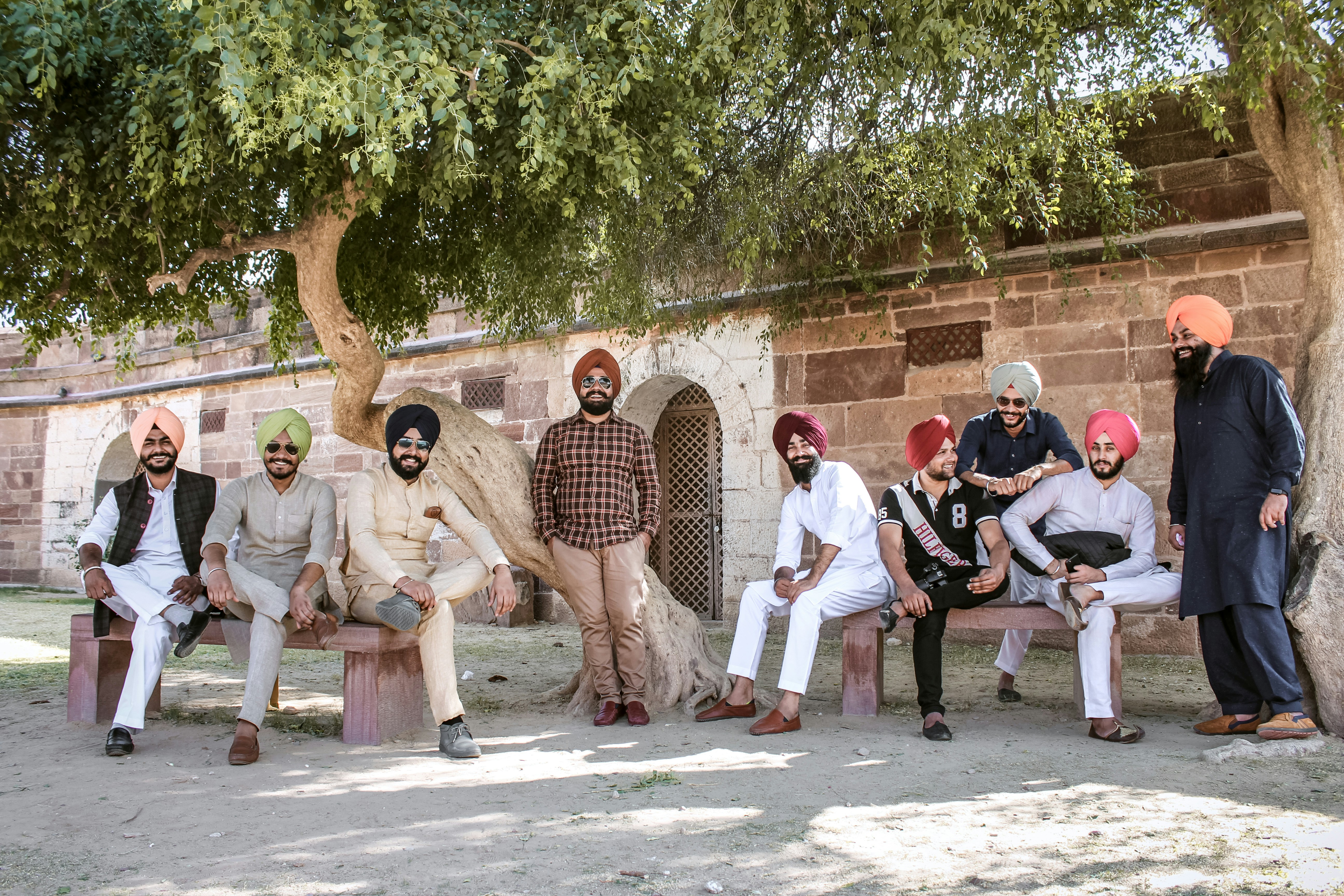 group of people sitting on brown concrete bench