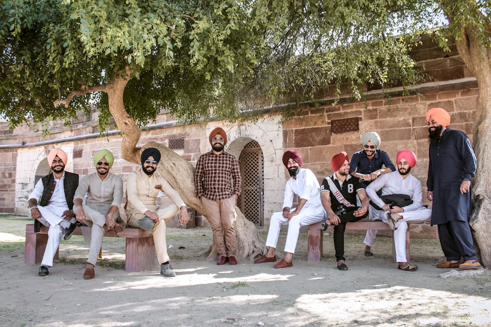 group of people sitting on brown concrete bench