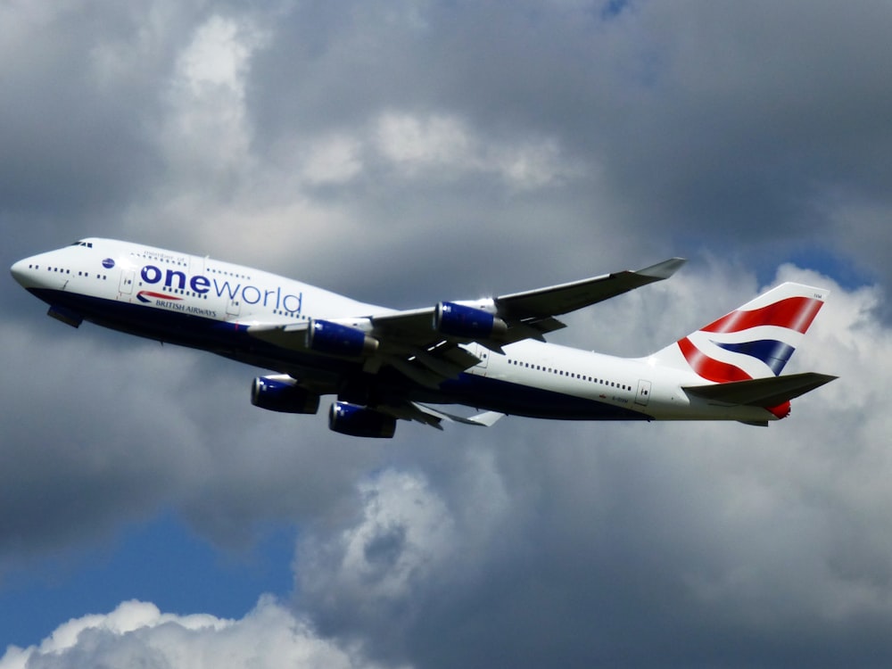 a large passenger jet flying through a cloudy sky