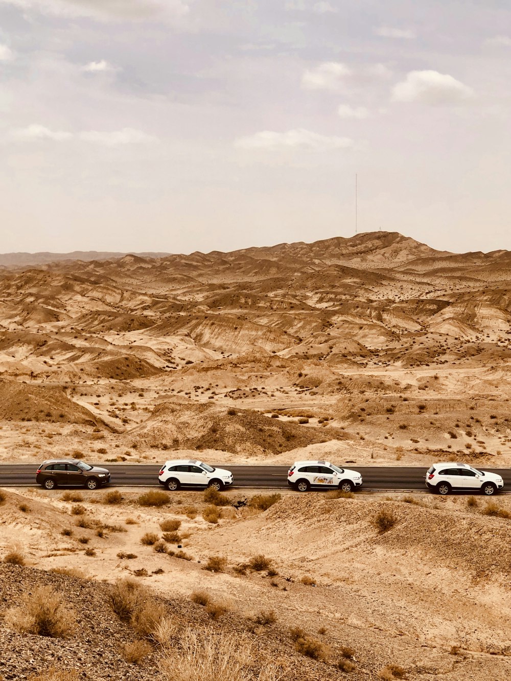 Coches en la carretera entre las montañas marrones durante el día