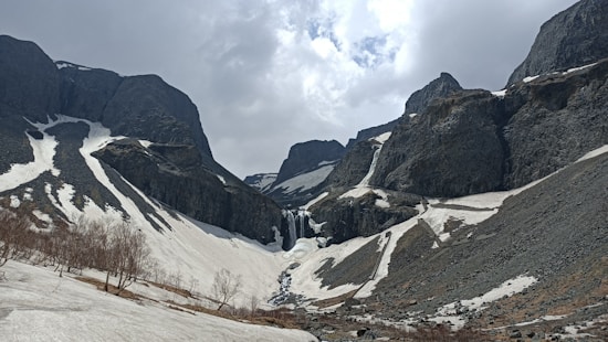 gray and white mountains under white clouds during daytime