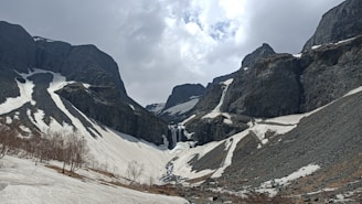 gray and white mountains under white clouds during daytime