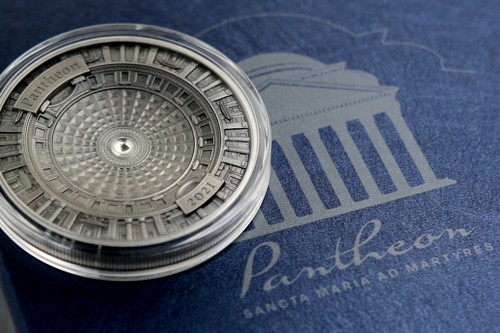 silver round container on blue textile