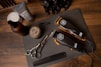 black and silver pocket knife beside silver round coins