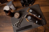 black and silver pocket knife beside silver round coins