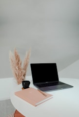 macbook pro on white table