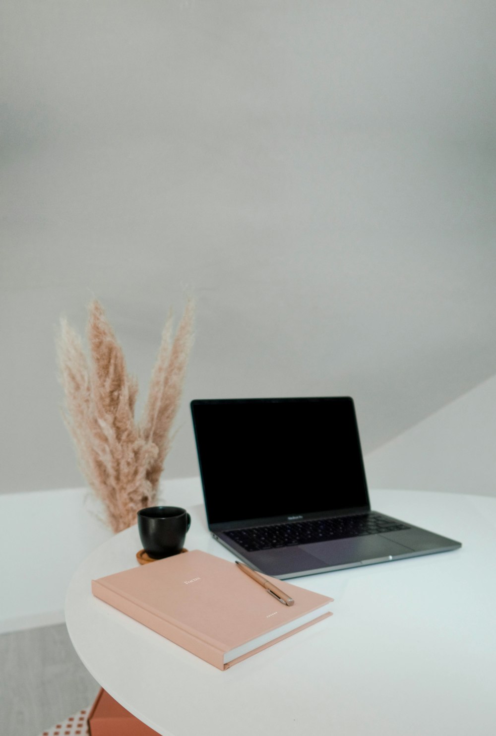 macbook pro on white table