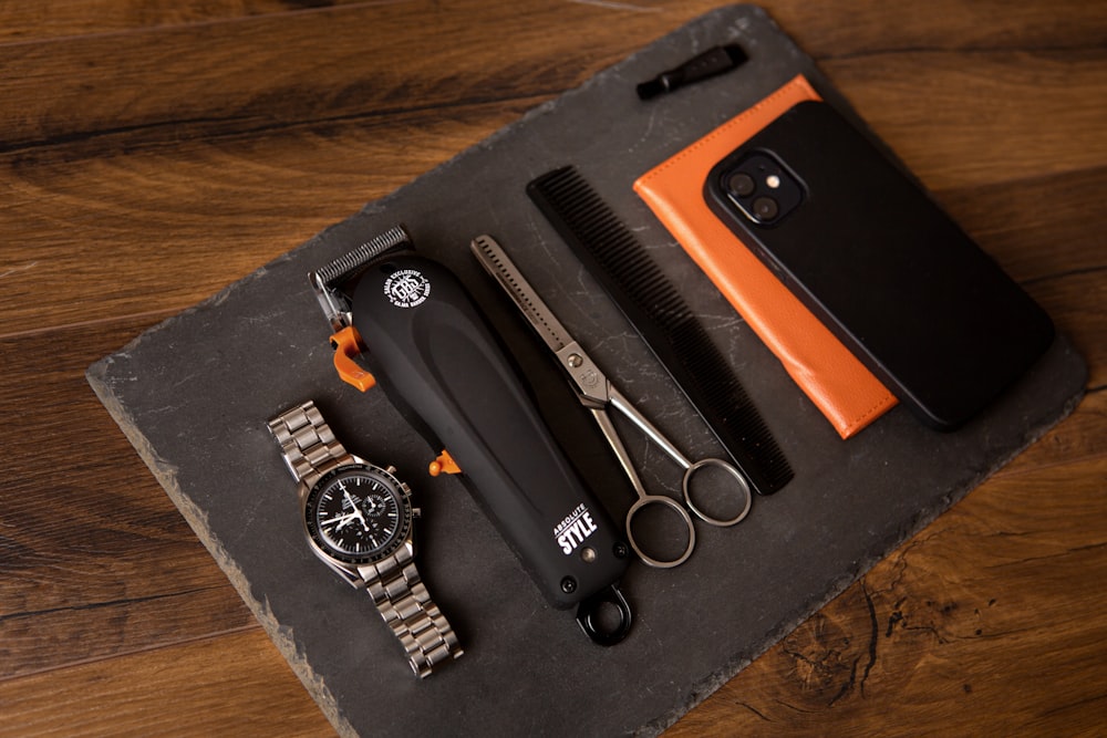 black iphone 5 with orange and black case