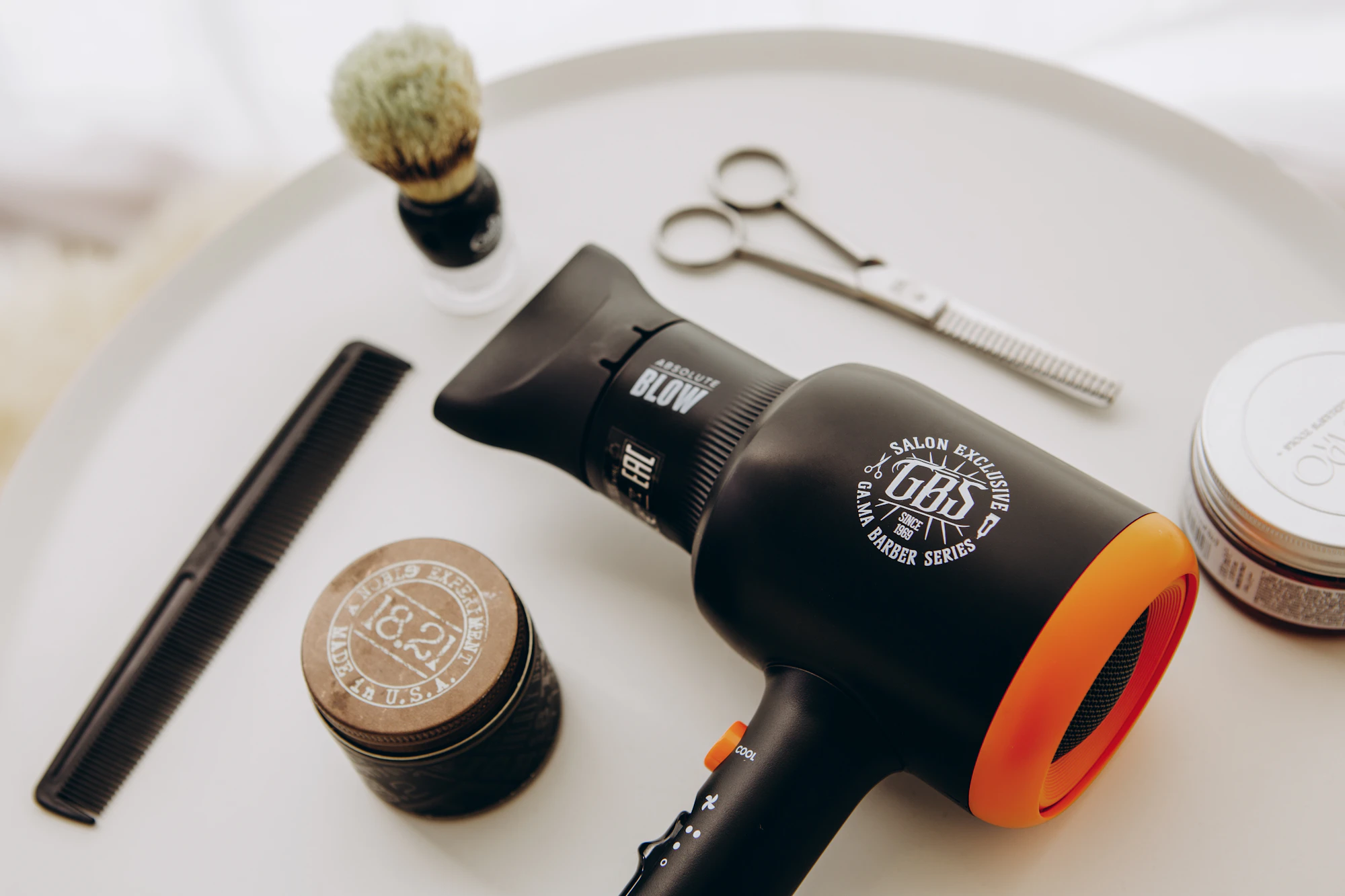 A vintage hair dryer from the mid-20th century, photographed on a pale background