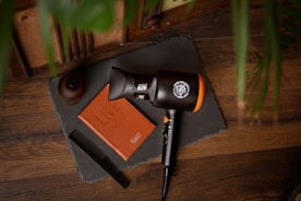black and orange microphone on brown wooden table
