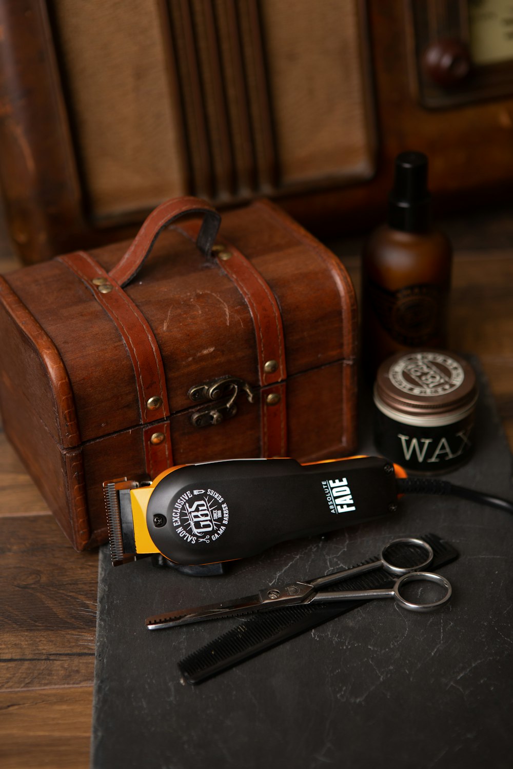 black and silver hair brush beside brown suitcase