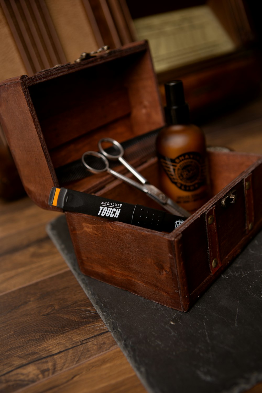 black and silver scissors on brown wooden box