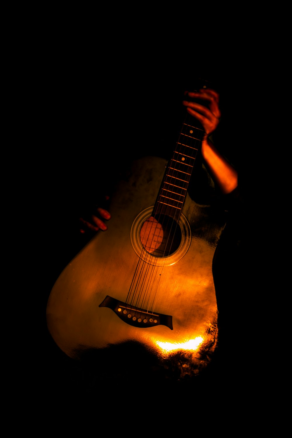 brown acoustic guitar on black background
