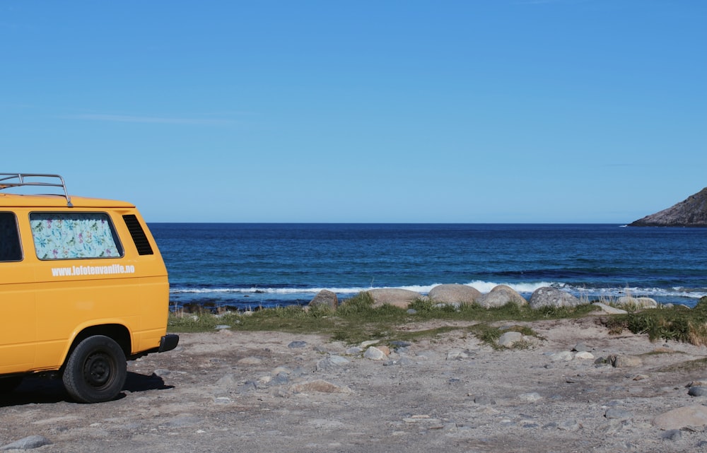 yellow van on beach shore during daytime