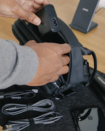 person holding black corded device