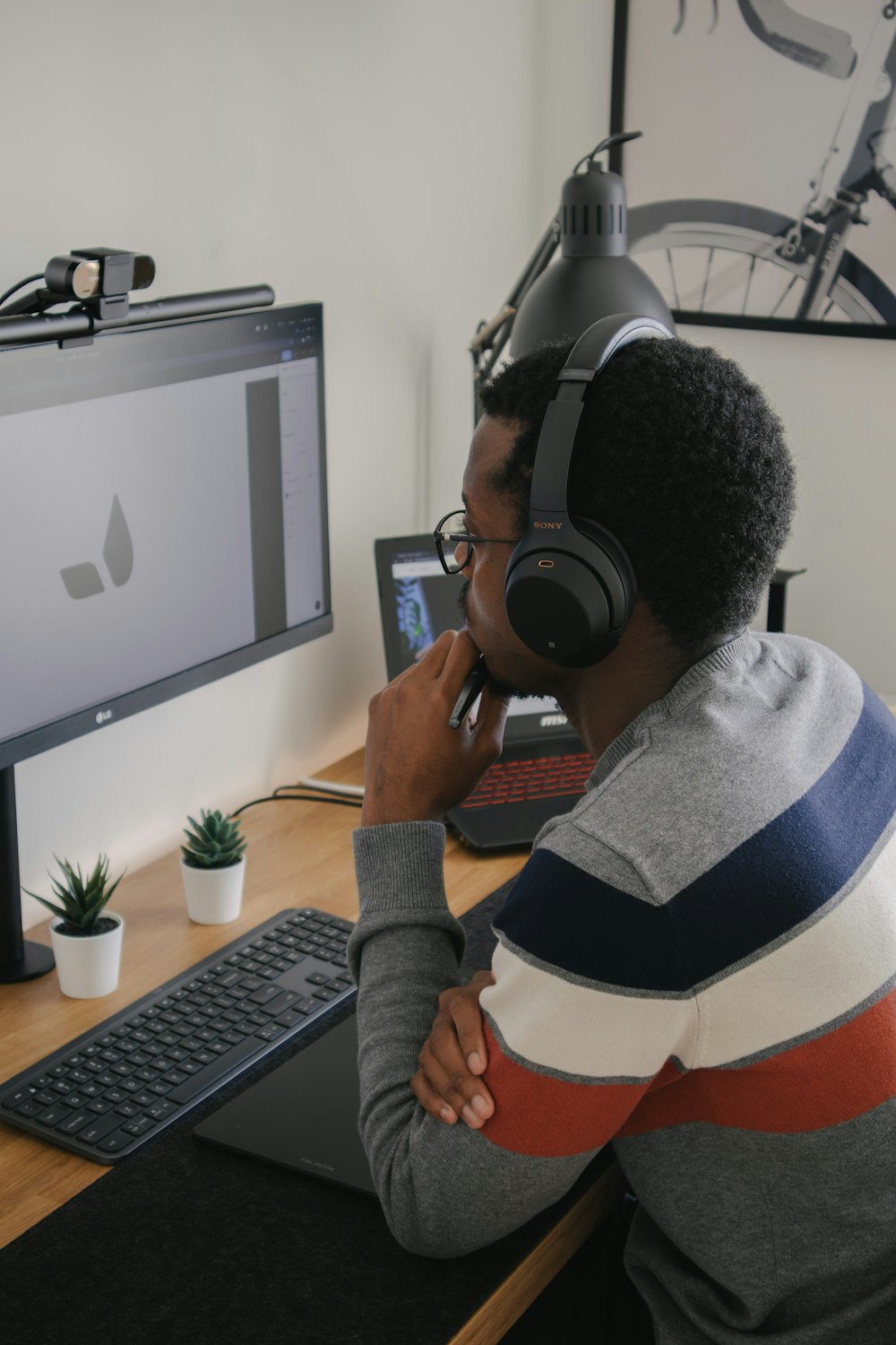 man in gray sweater wearing black headphones