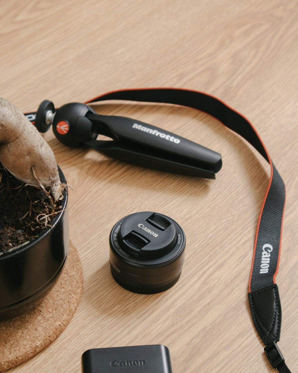 black and red hair brush beside brown wooden round container