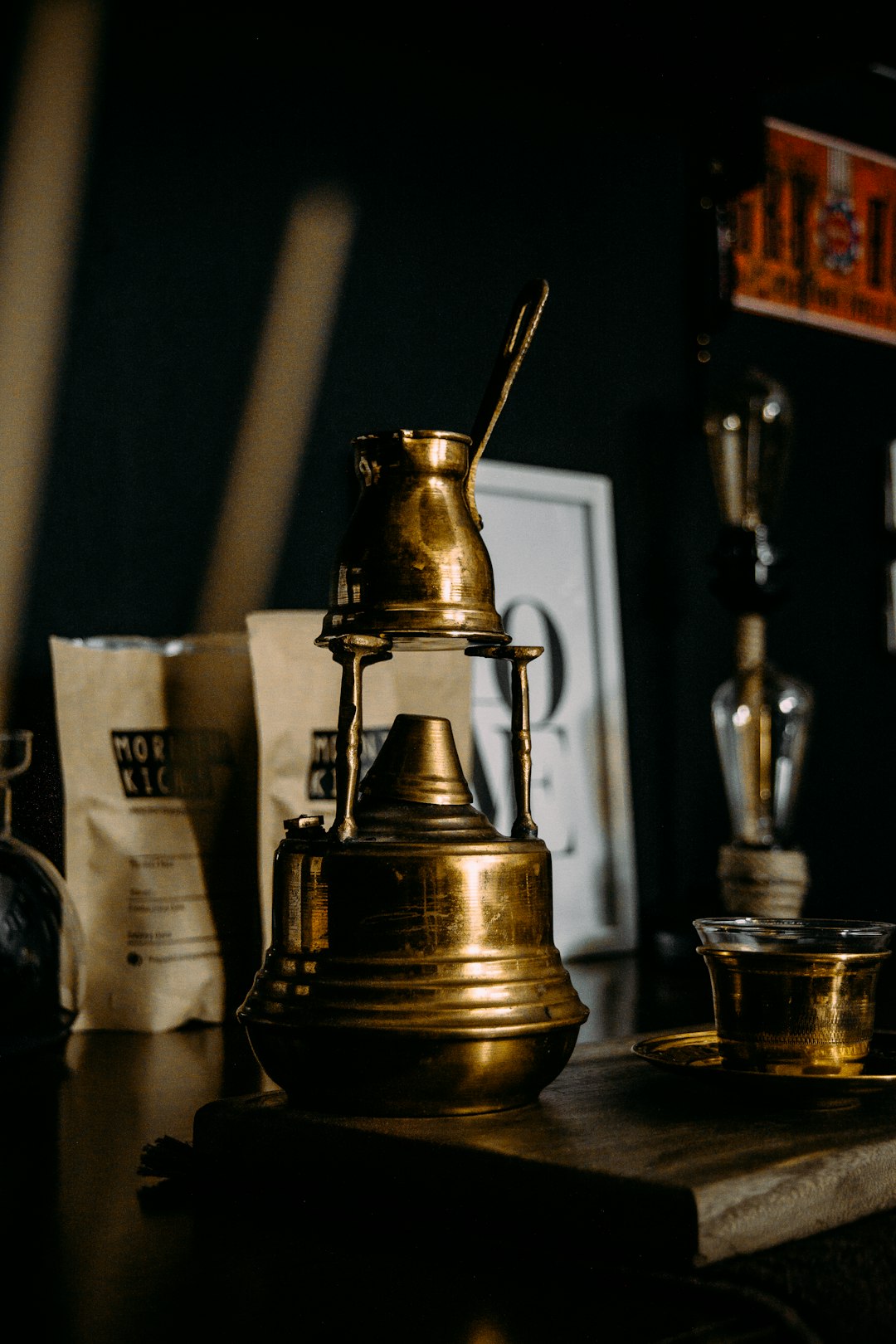 brass steel teapot beside clear drinking glass