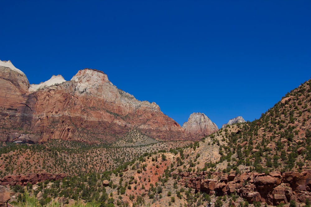 brown rocky mountain under blue sky during daytime