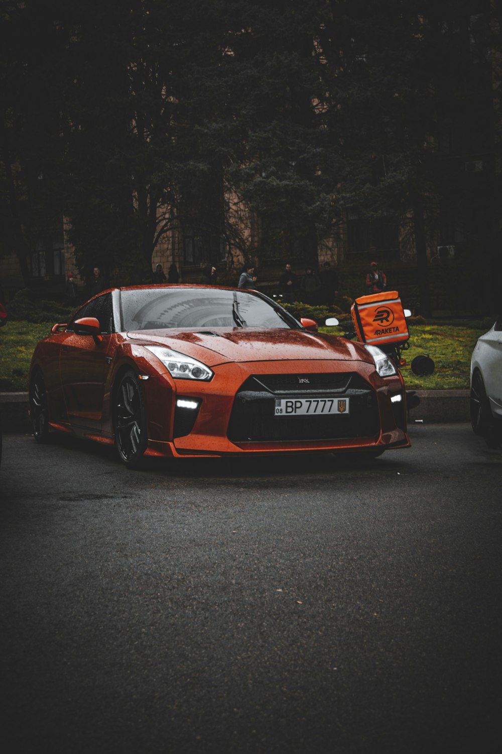 a red sports car parked on the side of the road