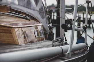 Technicians carefully restoring the wooden deck of a classic sailboat.