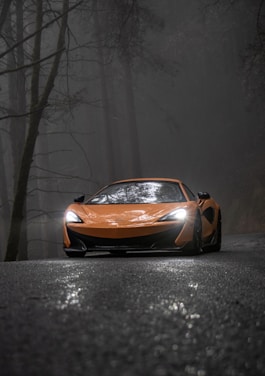 orange lamborghini aventador in a dark room