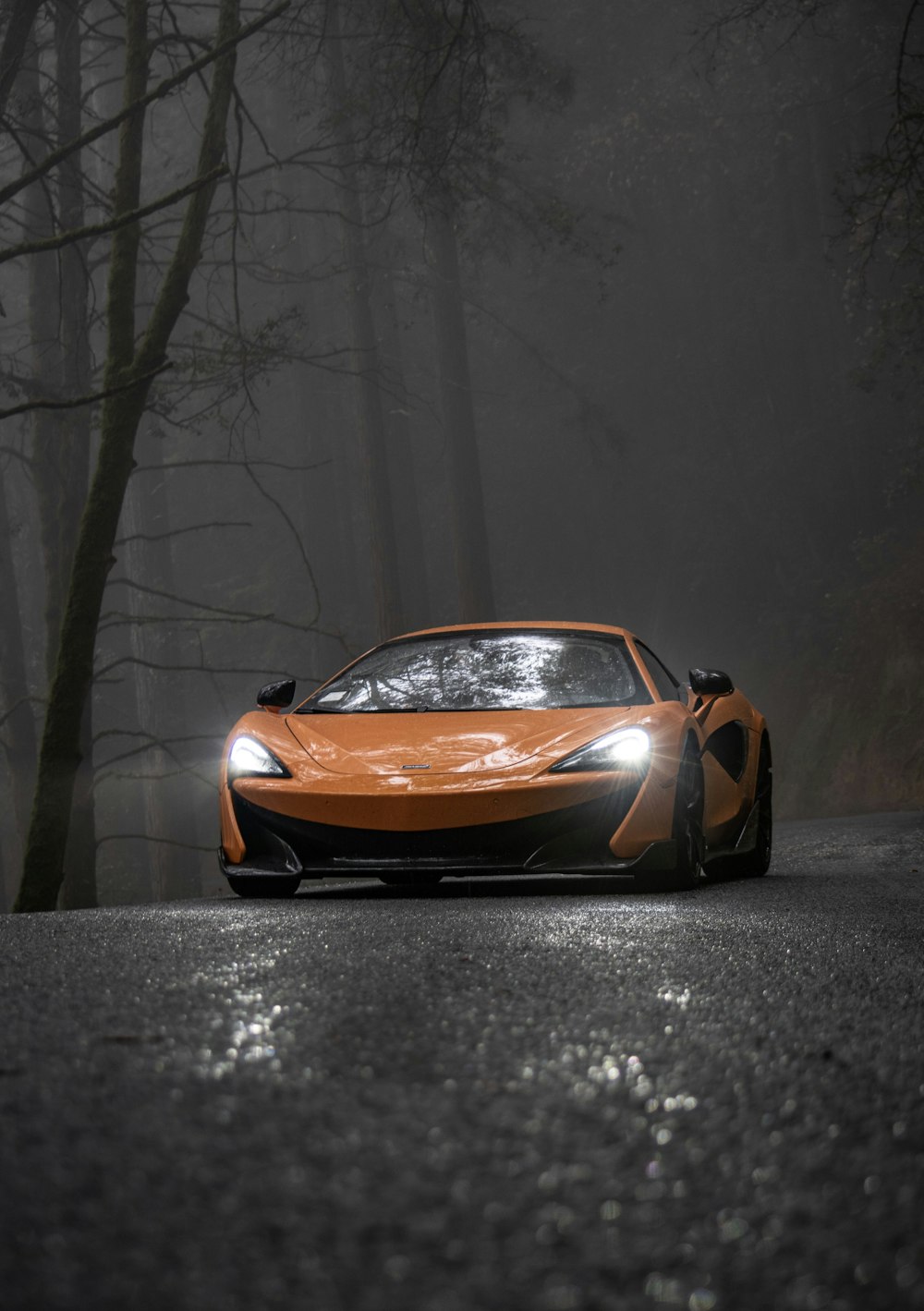 orange lamborghini aventador in a dark room