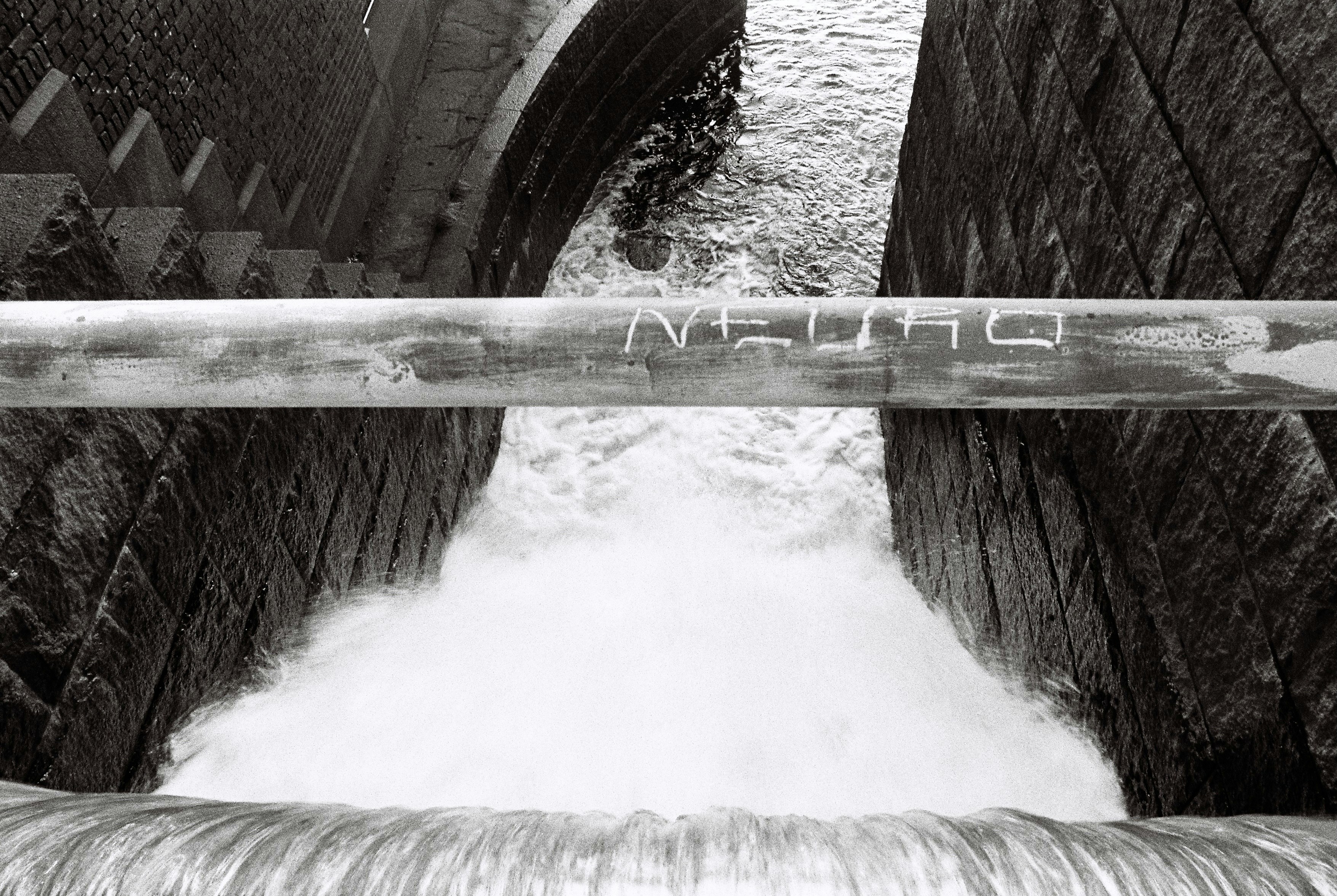 water falls on brown wooden bridge