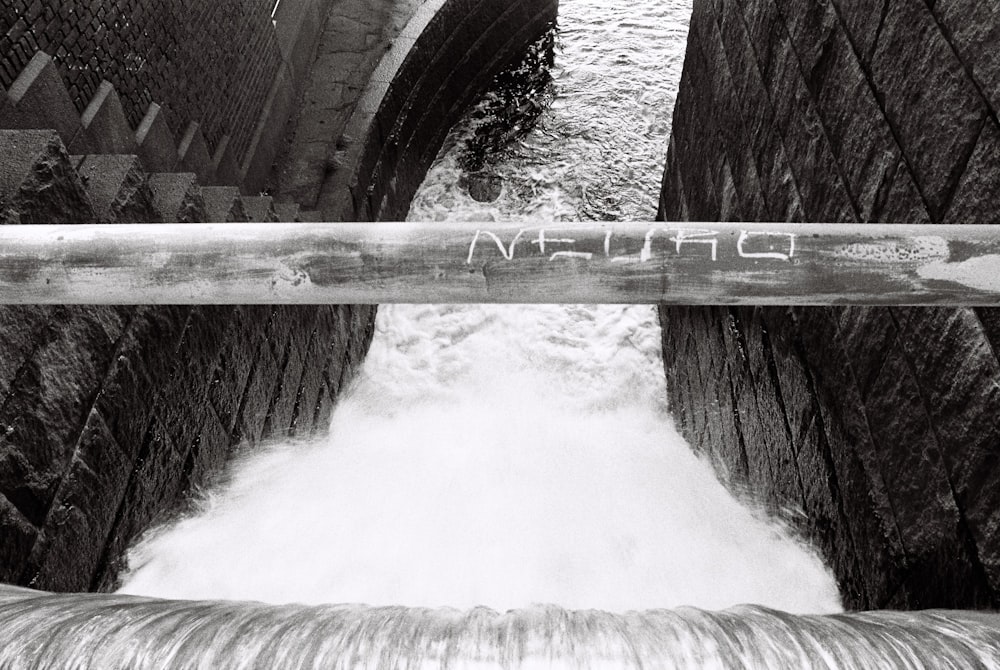 water falls on brown wooden bridge