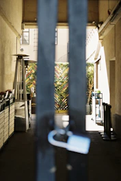 Sturdy metal gate installed at the entrance of a well-kept outdoor area.