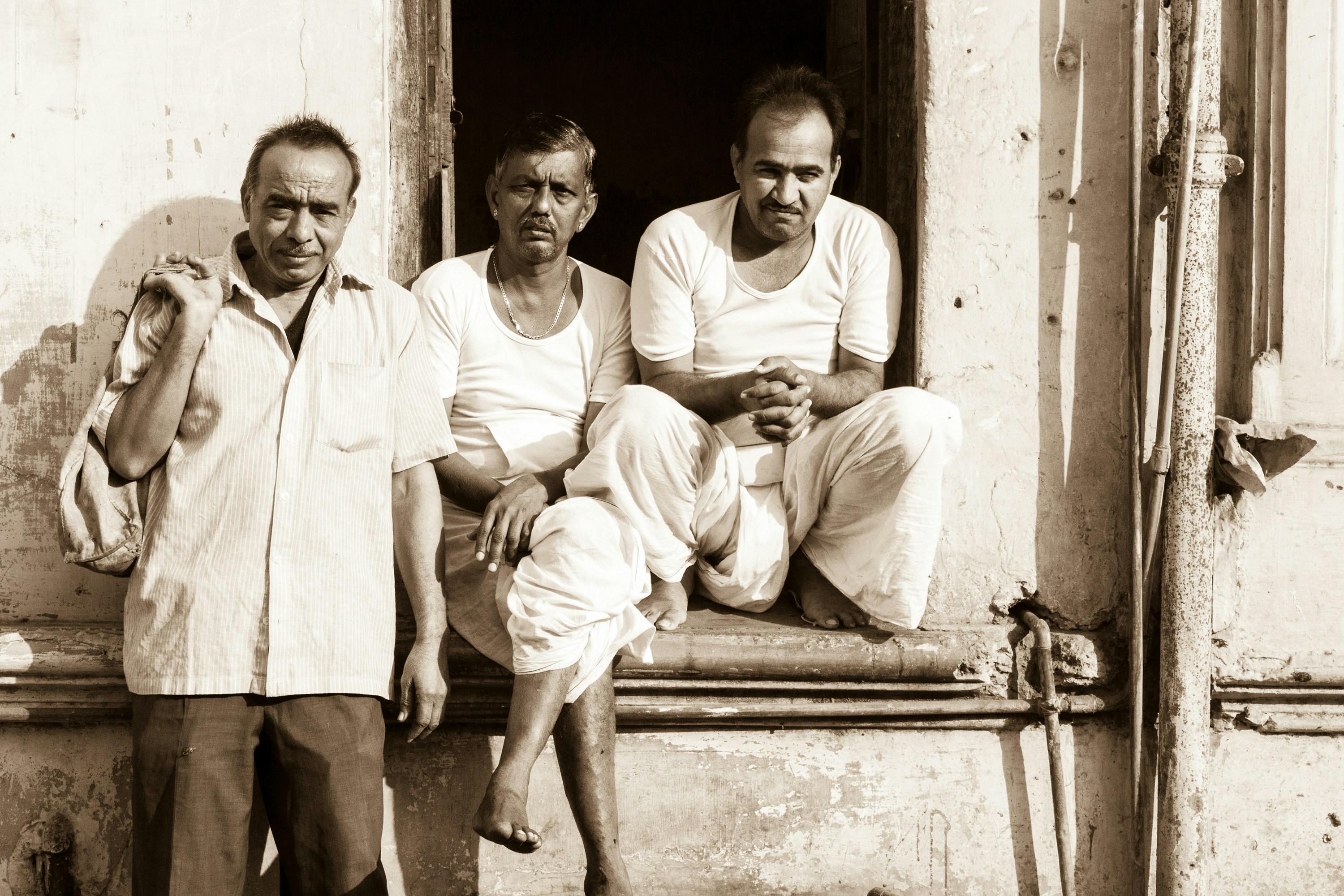 Two men sitting on wooden bench