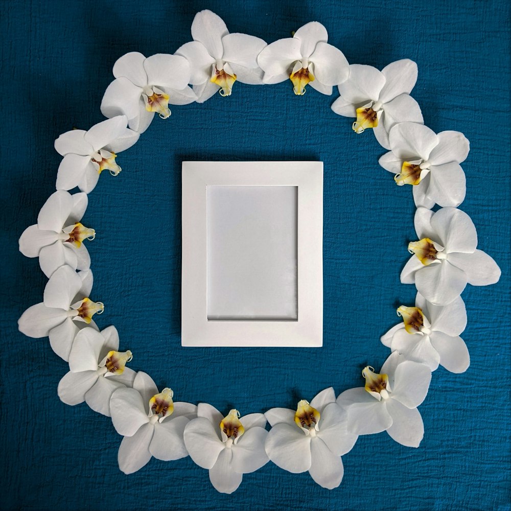 white wooden frame with white flowers