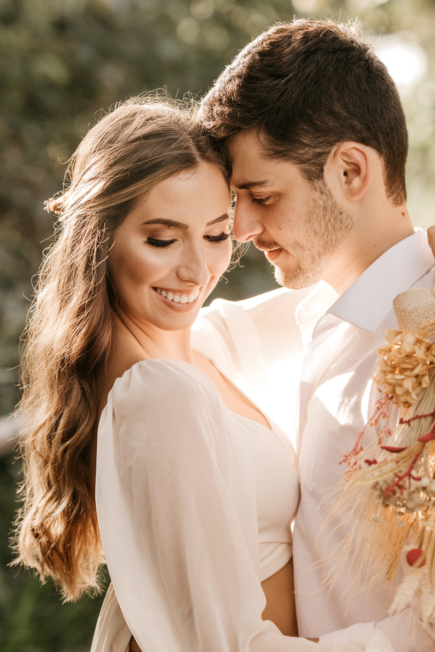 Wedding couple in white formal attire sharing an intimate moment showing the kind of photographs that result from effective photographer-couple communication before the day