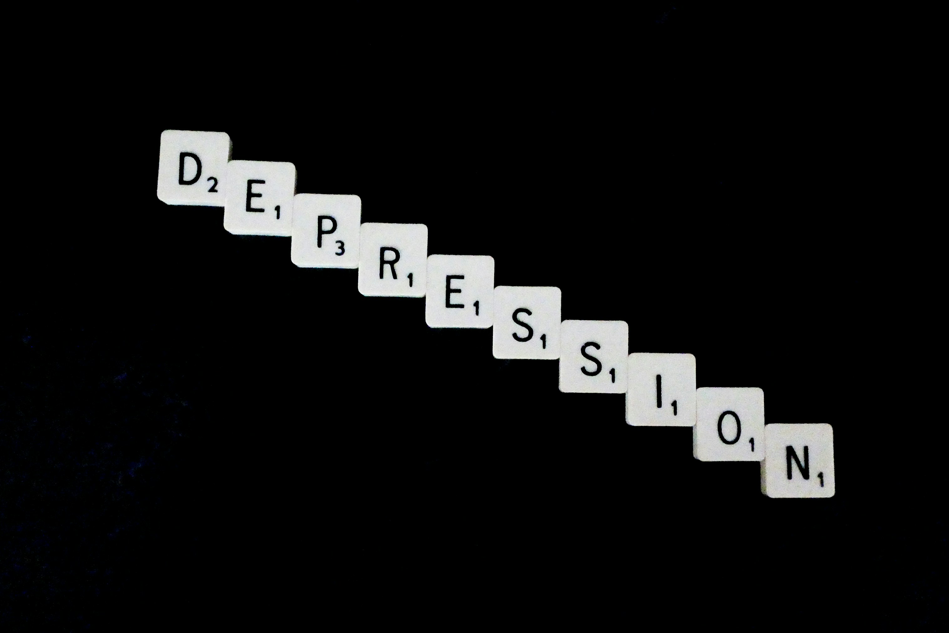 Depression, spelled out in white scrabble tiles.