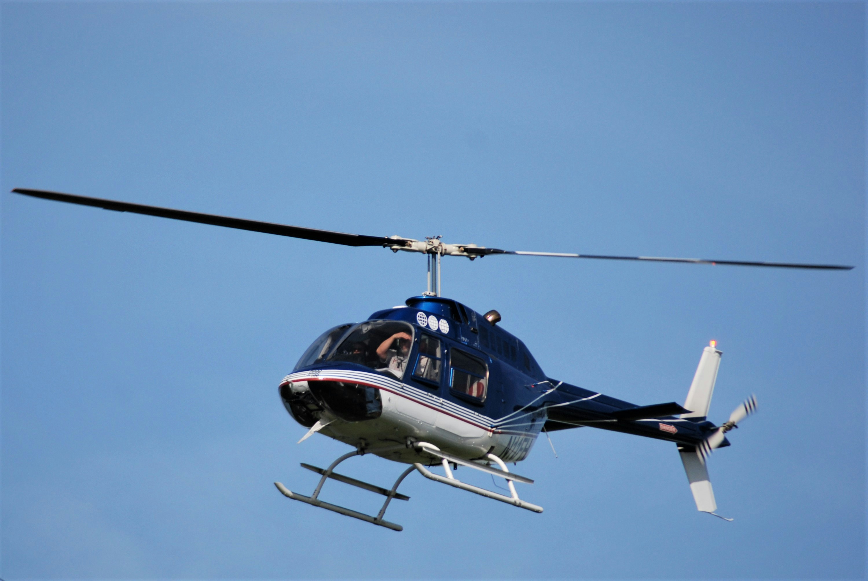 Private helicopter flying through the sky