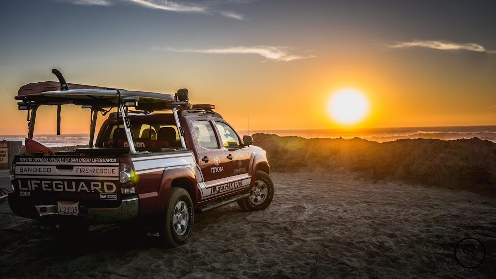 black suv on gray sand during sunset